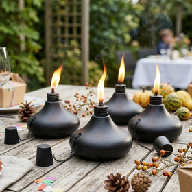 SNOGSWOG table-top torches create festive glow for garden parties.