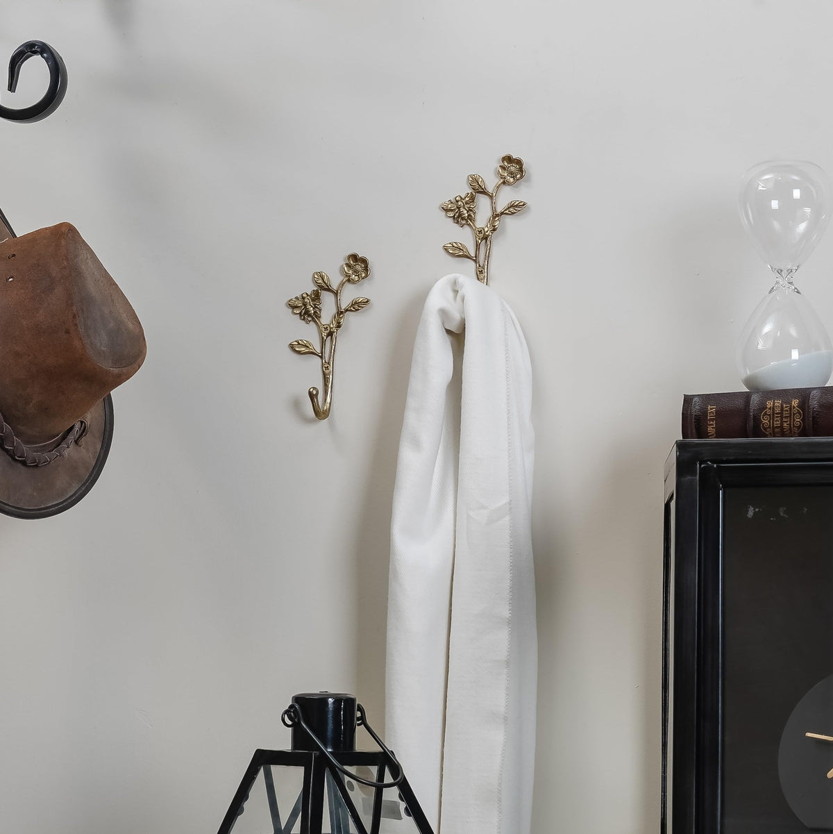 Close-up of the 3D bee detail on SOFFEE DESIGN hooks adds texture to entryway