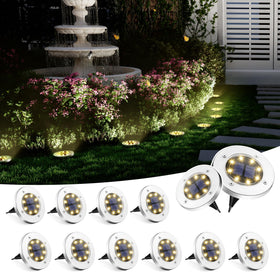 SOLPEX solar ground light with 8 LEDs guiding garden pathways at night.