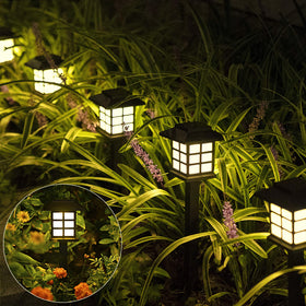 SOLPEX solar path lights with house-style warm white glow along a garden path