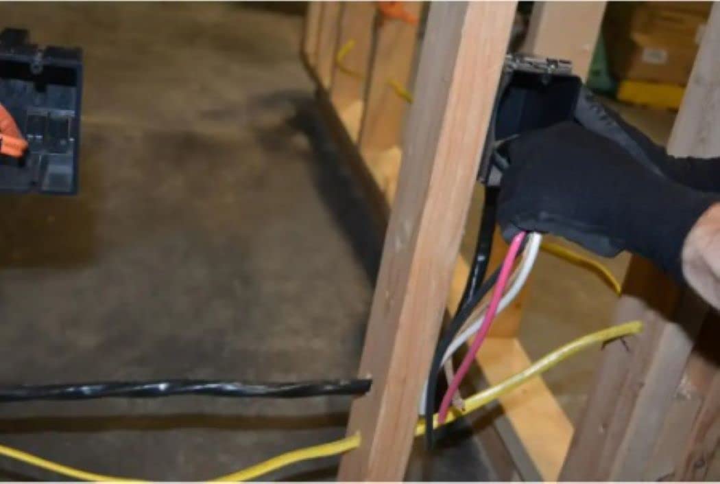 Southwire NM-B conductor close-up shows color-coded wires for correct pairing.