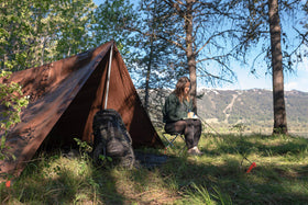 Stansport versatile tarp shields firewood piles and gear.