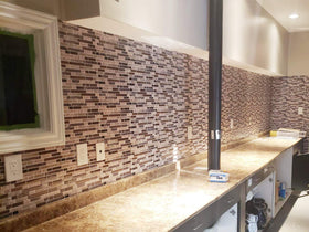 Stickgoo 12x12-inch panels installed for seamless coverage in a kitchen area.