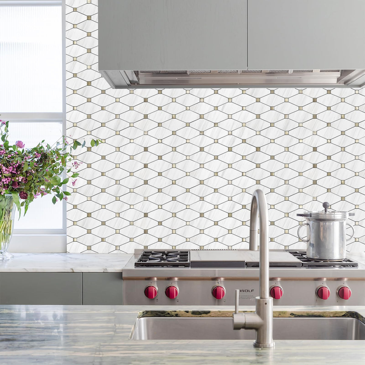 STICKGOO Dolomite mosaic with gold metal accents adds subtle sparkle to walls.