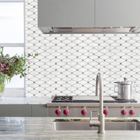 STICKGOO Dolomite mosaic with gold metal accents adds subtle sparkle to walls.
