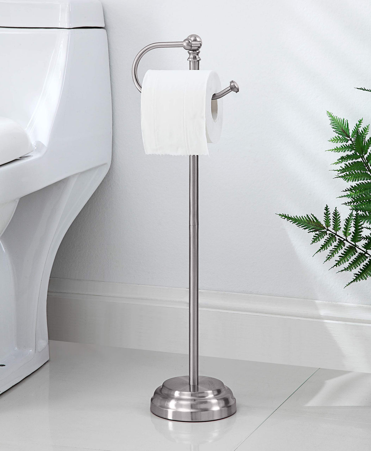 The freestanding stand in brushed chrome sits securely with a weighted base.
