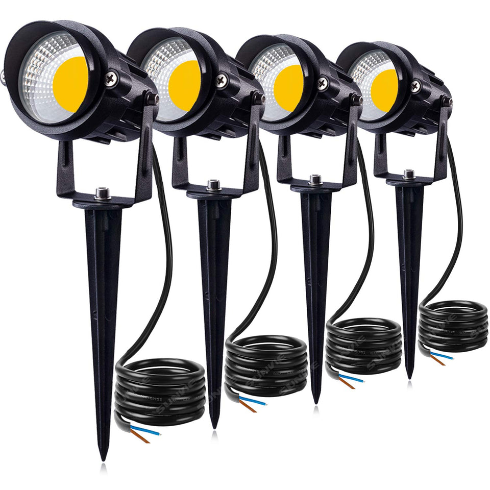 SUNVIE 12W LED landscape light brightens a patio wall with warm glow.