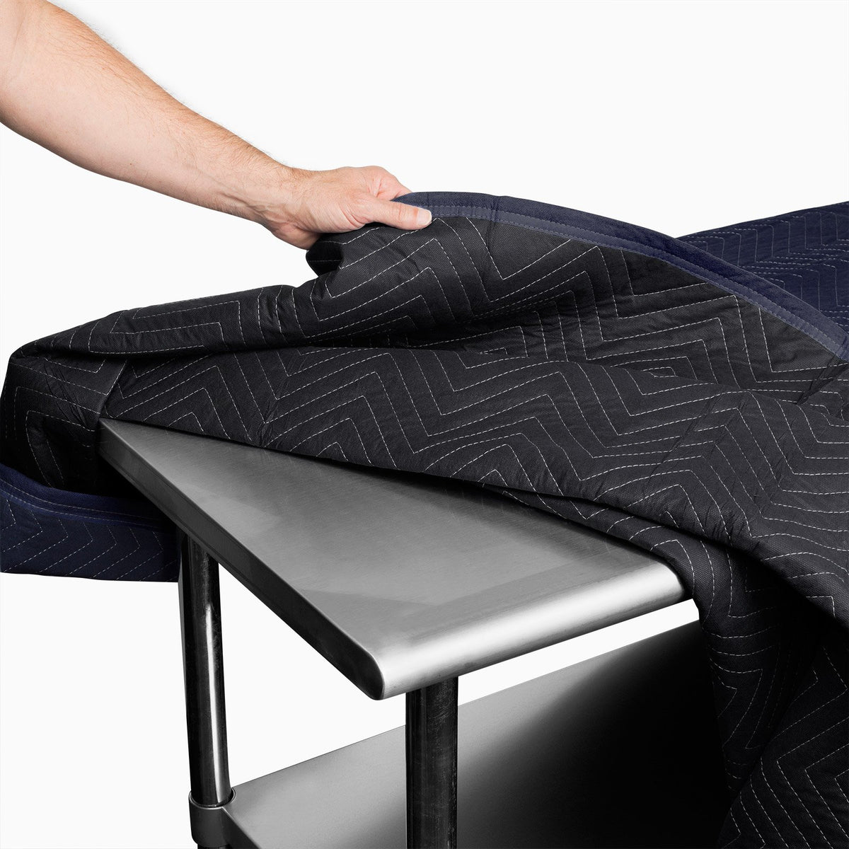 Sure-Max moving pad 80x72 navy blue in use, wrapped around a sofa for safe transport.