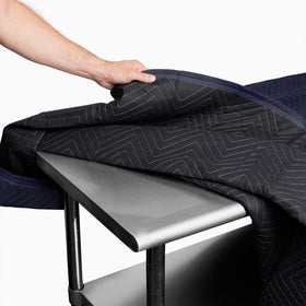Sure-Max moving pad 80x72 navy blue in use, wrapped around a sofa for safe transport.