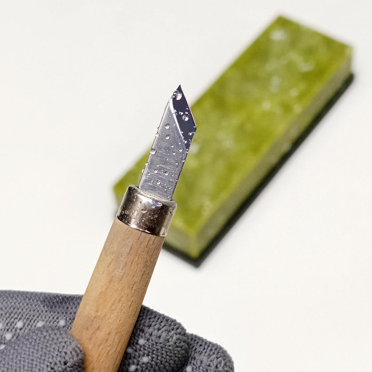 Suwajume stone in use on a kitchen knife for precise honing.