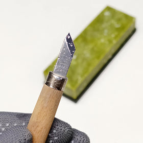 Suwajume stone in use on a kitchen knife for precise honing.