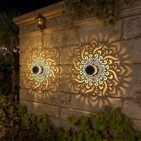 SXXSMYWR outdoor solar mandala light illuminating garden walls with a warm glow.
