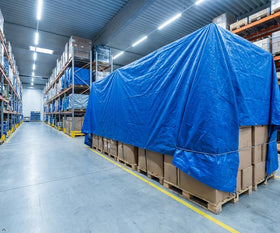 Taditus tarp covering equipment in a shed to guard against dust