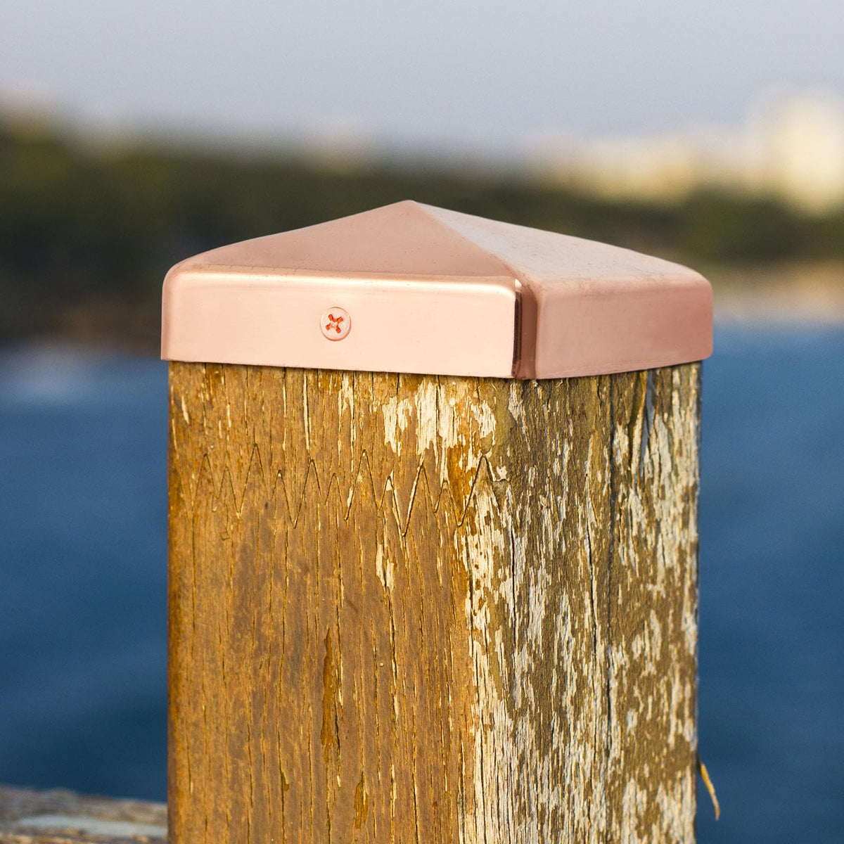 Tandefio copper pyramid post cap installed on a fence post—sleek protection.