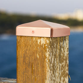 Tandefio copper pyramid post cap installed on a fence post—sleek protection.