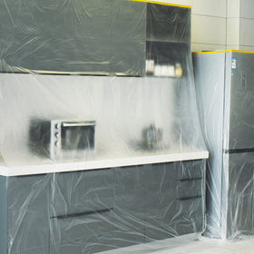TAPEBEAR paint film protects floors during painting and cleanup