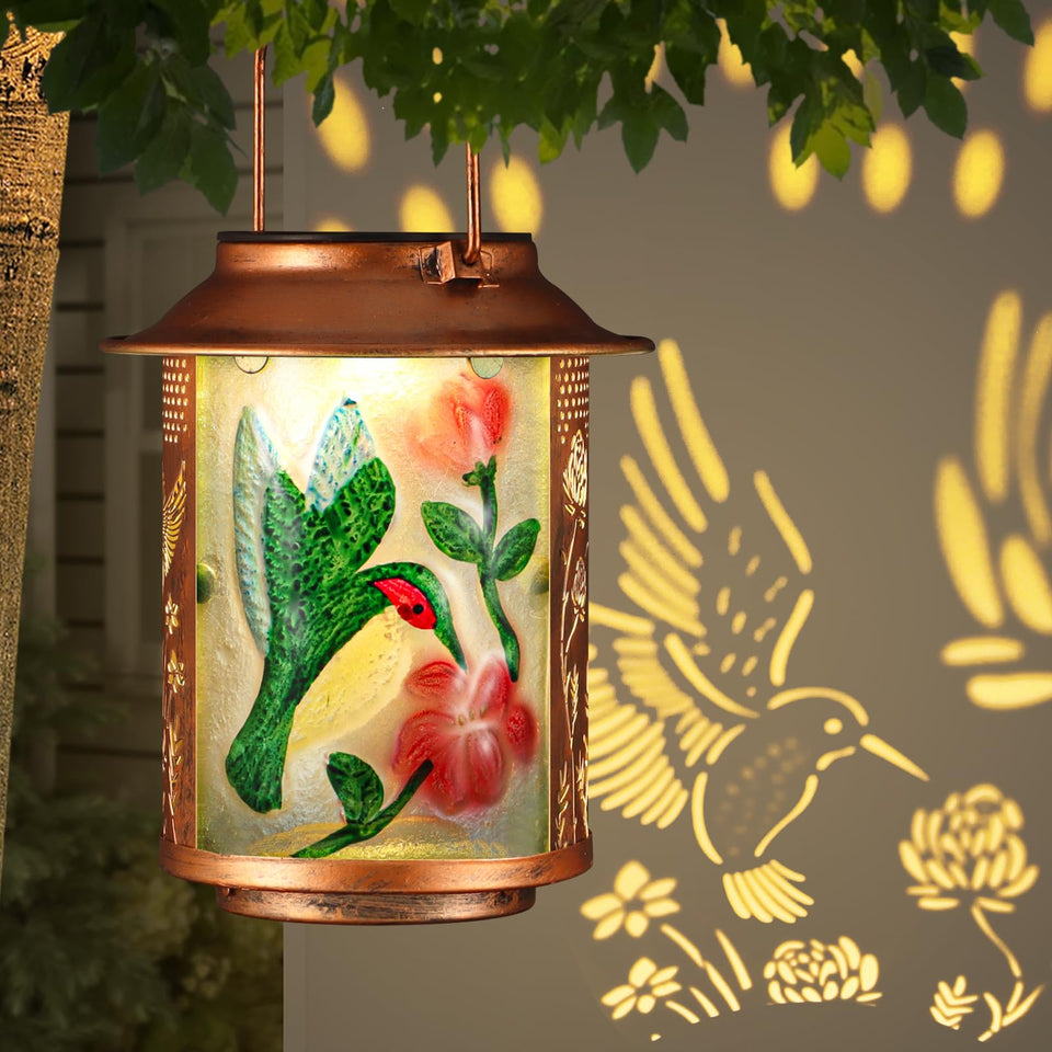 Tepaken hummingbird solar lantern outdoors with warm pattern projection
