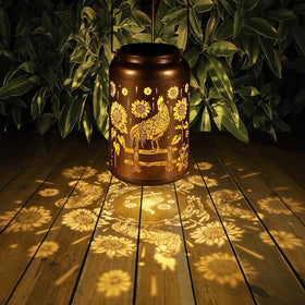 Metal Tepaken lantern in a gold finish adds durable, stylish yard decor.