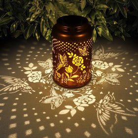 Tepaken Rose Butterfly lantern hanging in a garden for warm ambience.