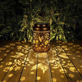 Tepaken solar lantern in gold copper finish adds elegant patio decor.