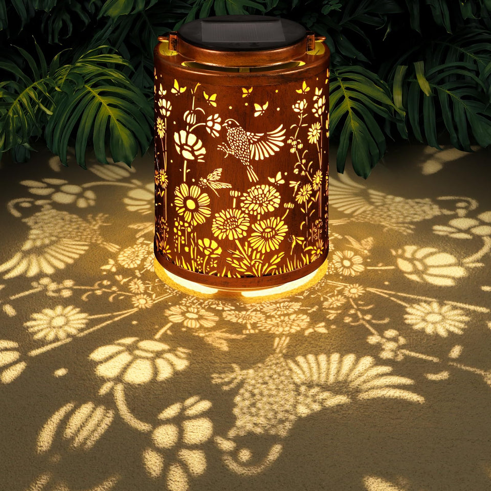 Tepaken solar lantern with hummingbird pattern creates warm garden ambiance