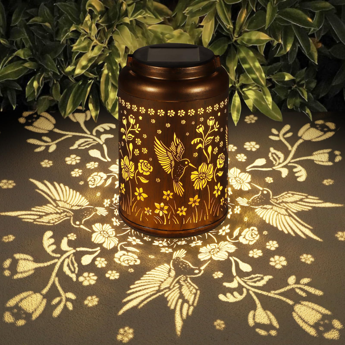 Tepaken solar lantern hummingbird design casts a warm garden glow at dusk