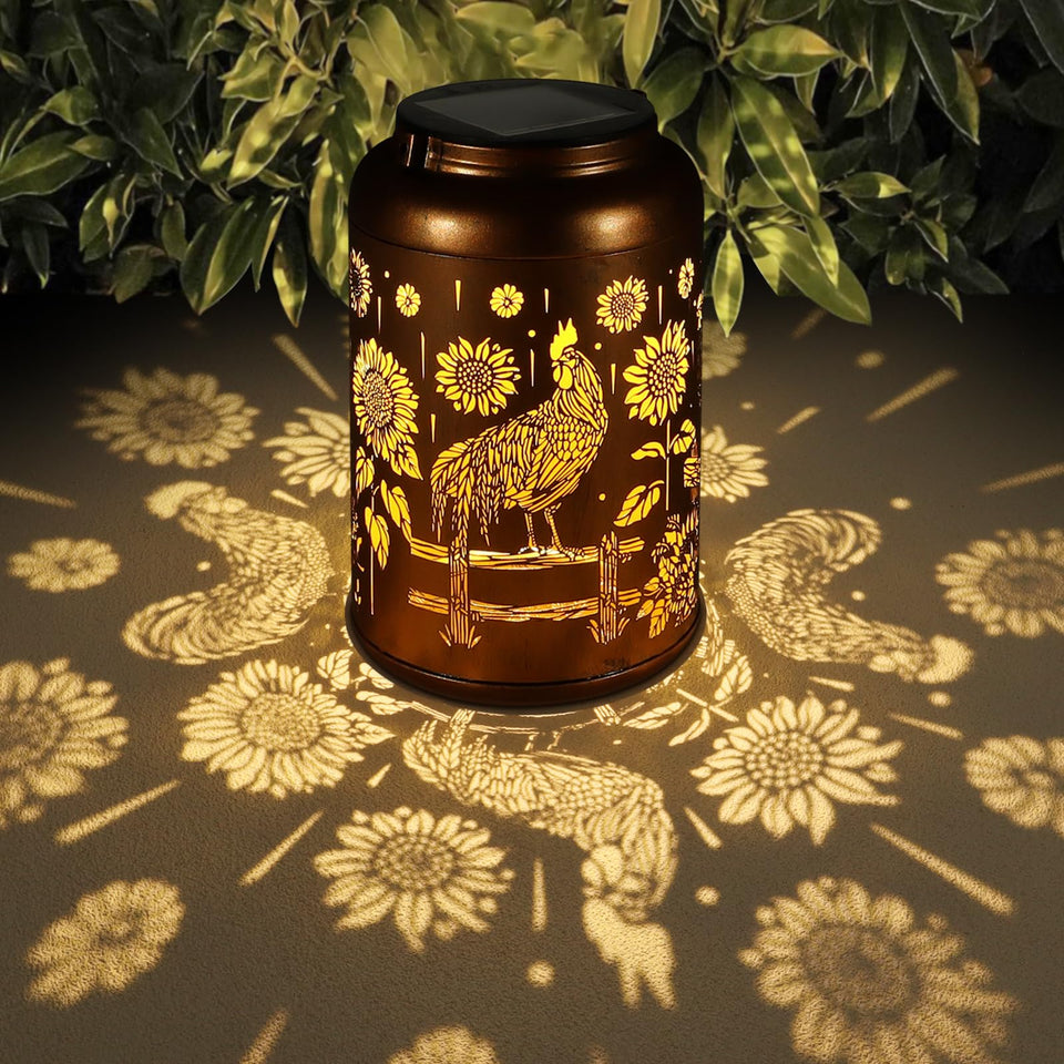 Tepaken solar lantern with hummingbird pattern casts a warm garden glow.