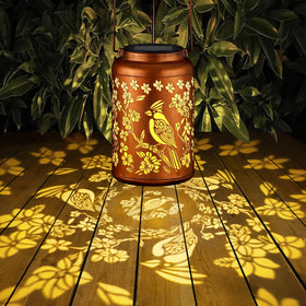 Tepaken Red Bird Solar Lanterns on flat surface brighten patios without wiring.