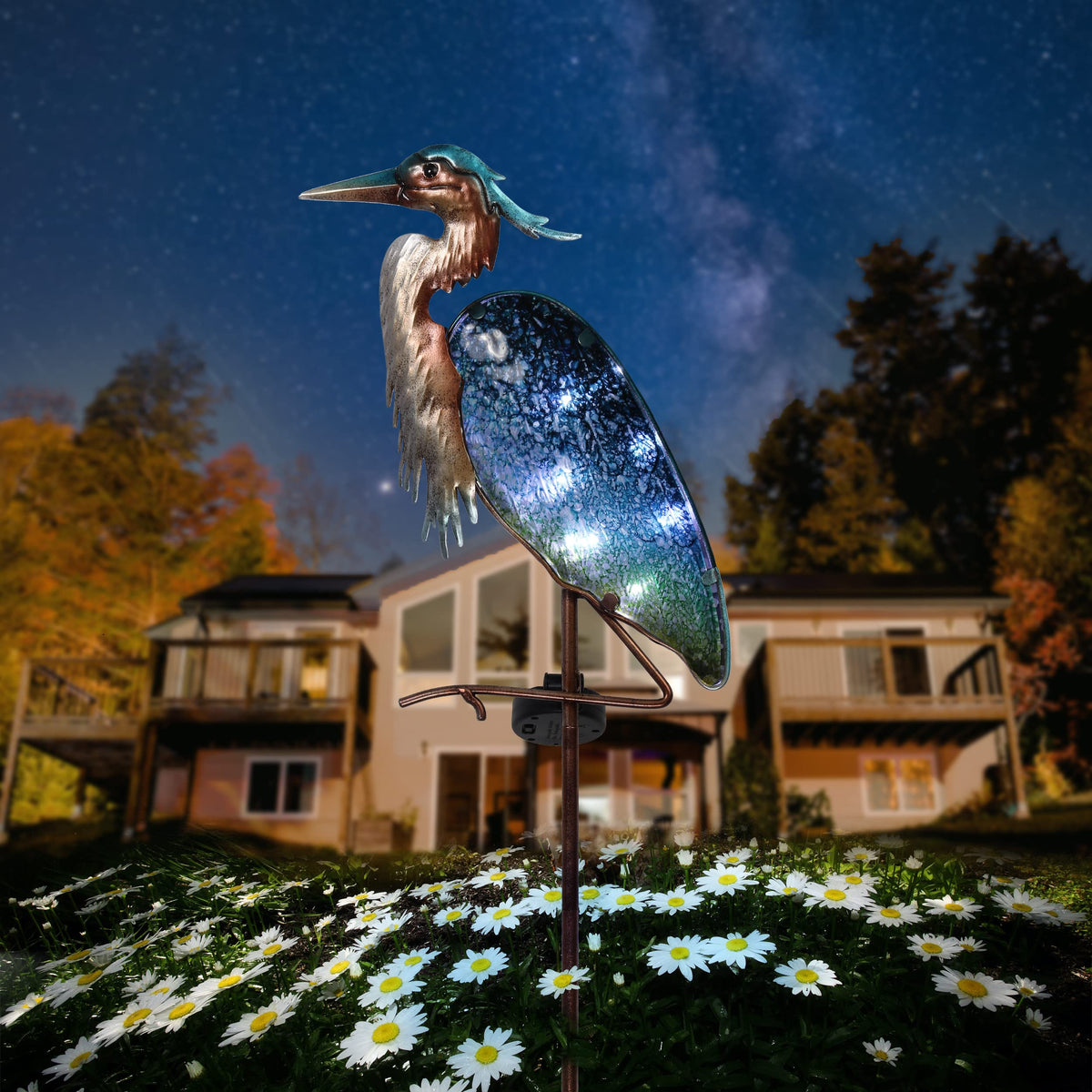 Teresa's Collections blue heron solar light brightening garden pathways.