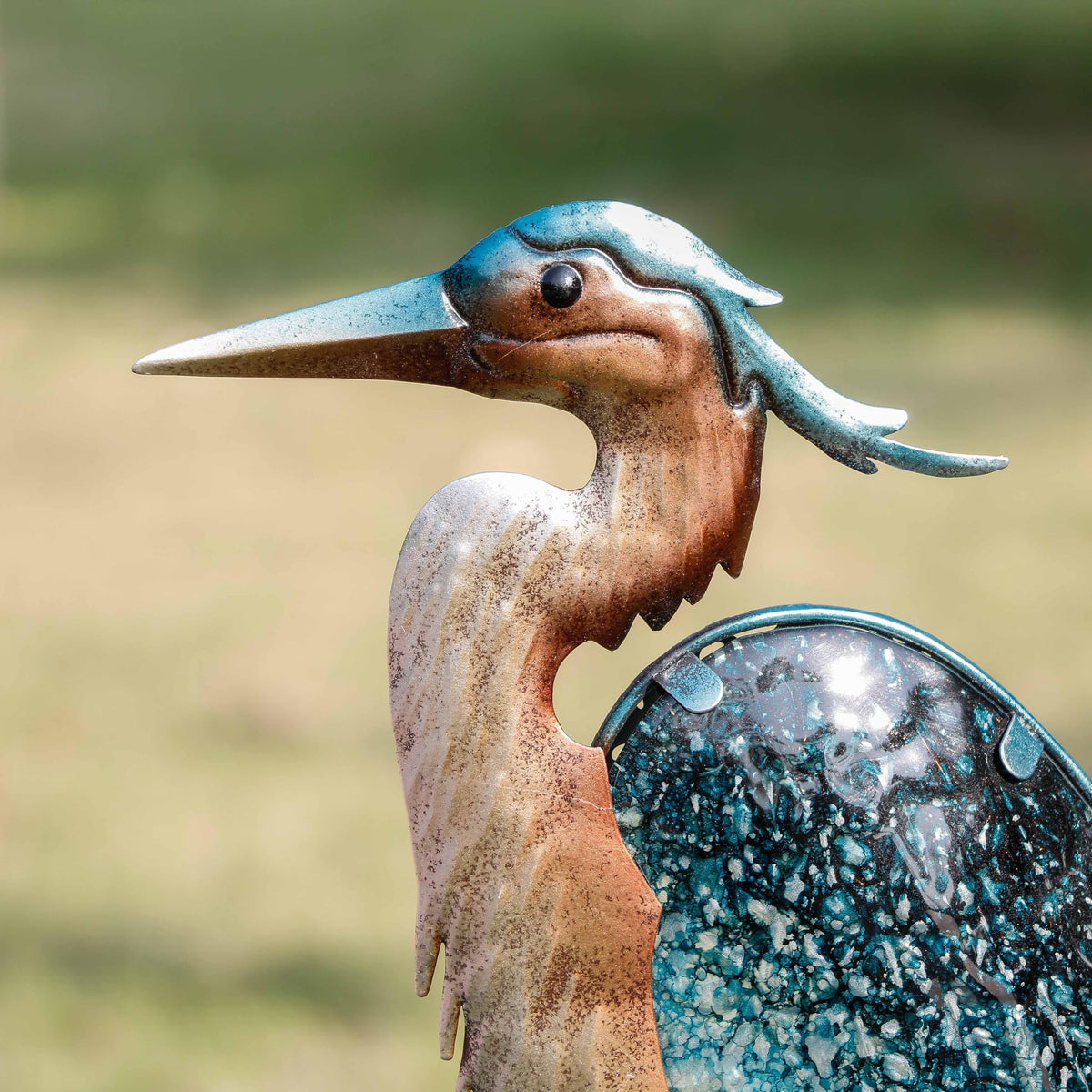 Teresa's Collections blue heron yard art automatically lights at night for ambience.