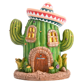 Teresa's Collections cactus fairy house Cinco de Mayo decor glows softly at night in outdoor spaces.