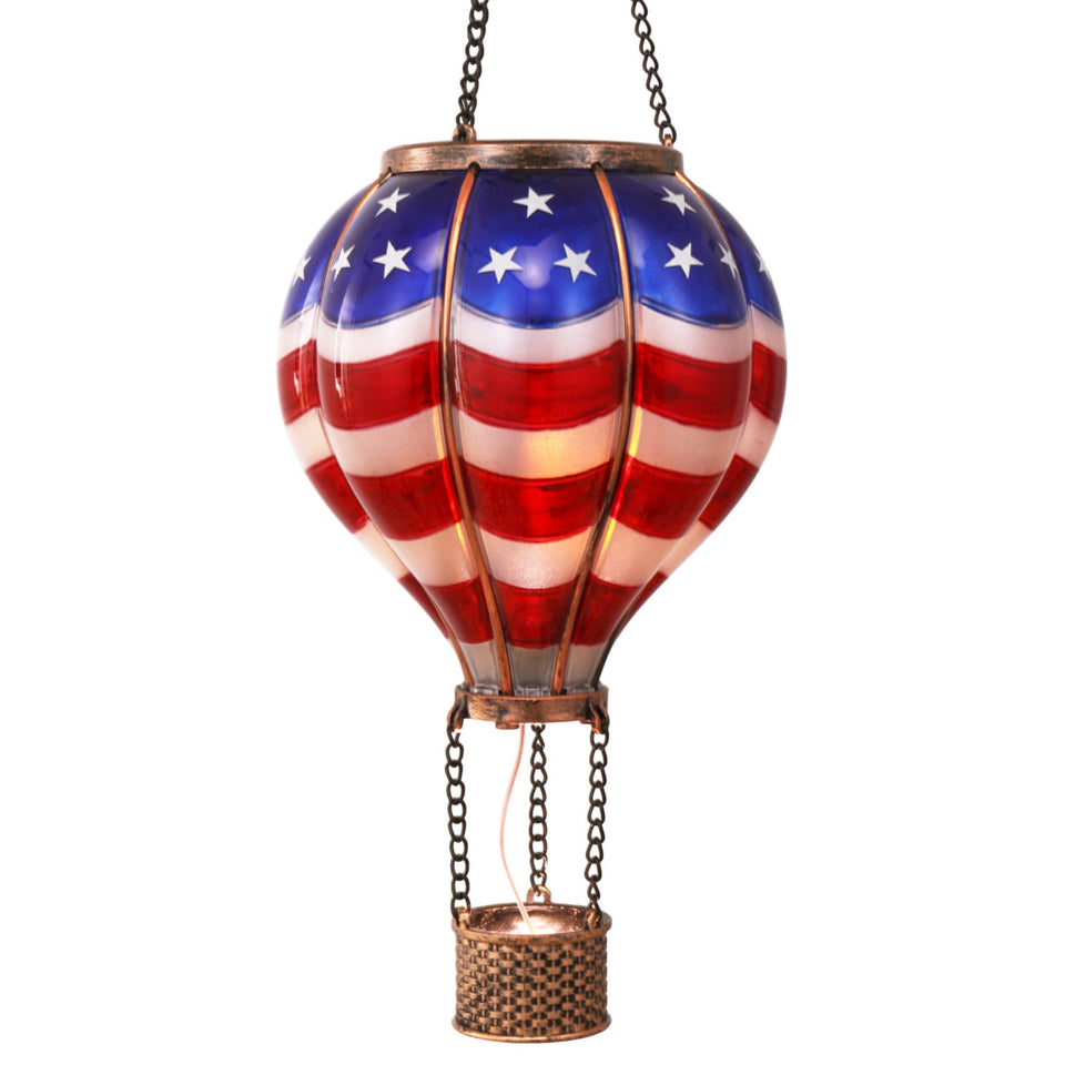 TERESA'S COLLECTIONS hot air balloon lantern in blue and red glows softly for patriotic outdoor decor.