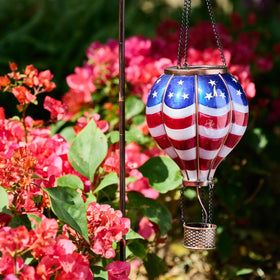 TERESA'S COLLECTIONS waterproof plastic lantern stands up to weather while keeping its charm.