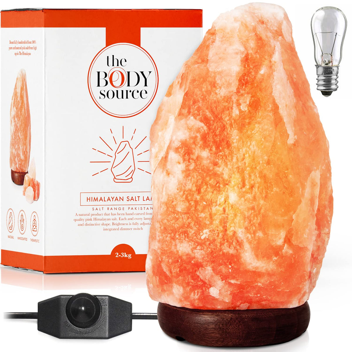 The Body Source Himalayan salt lamp with wooden base creates warm ambient lighting.