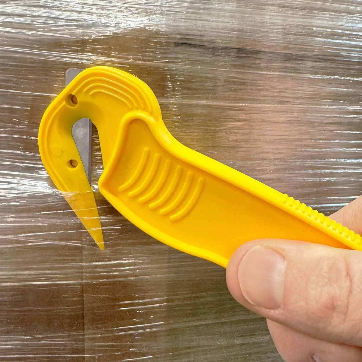 Cuts tape and plastic straps without damaging products.