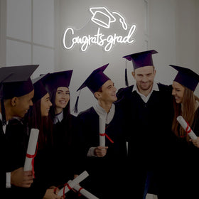 Threan neon sign for photo booth background creates memorable graduation moments.