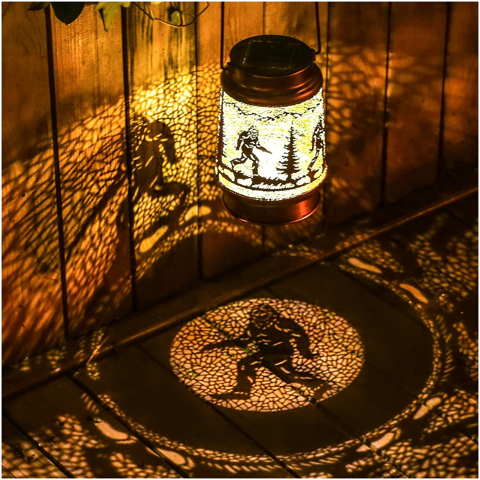 TIGGSY Bigfoot solar lantern with bronze finish casts warm garden patterns.
