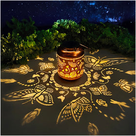 TIGGSY Butterfly Solar Lantern casting butterfly-pattern shadows at dusk.