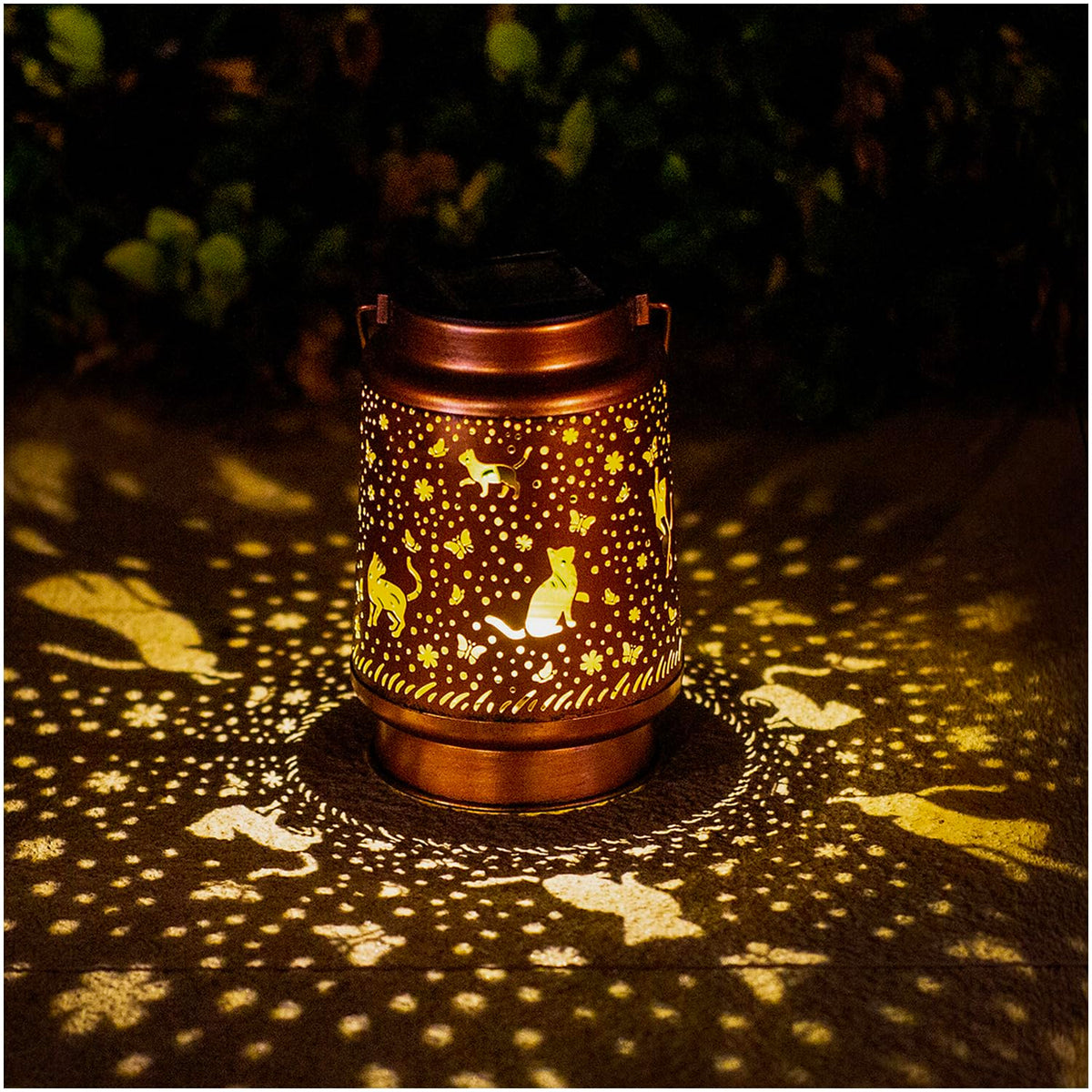 TIGGSY Cat Solar Lantern showing decorative pattern projected at night.