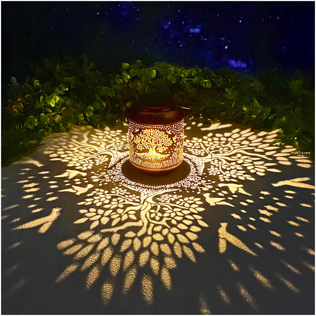 TIGGSY Tree of Life lantern hanging with decorative pattern adds cozy garden ambience.