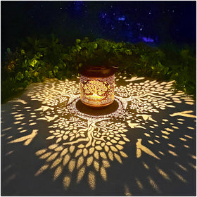 TIGGSY Tree of Life lantern hanging with decorative pattern adds cozy garden ambience.