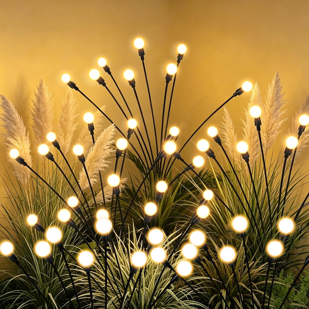 Tigrelight 4 pack solar firefly lights illuminating a walkway with warm glow