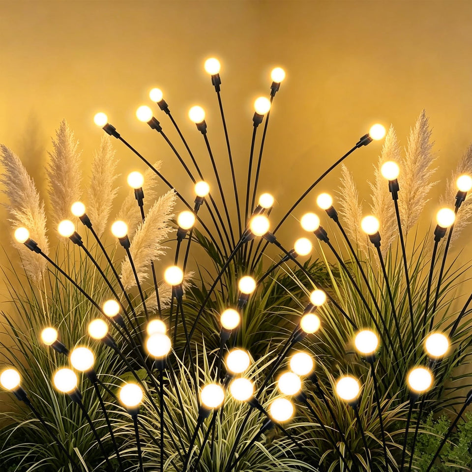 Tigrelight 4 pack solar firefly lights illuminating a walkway with warm glow