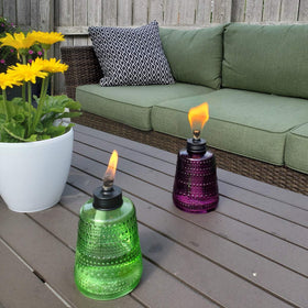 TIKI Carnival Glass Torch blue lit, warm glow along patio dining