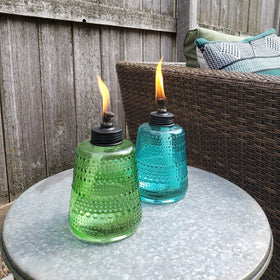 TIKI Carnival Glass Torch green lit for cozy backyard evenings