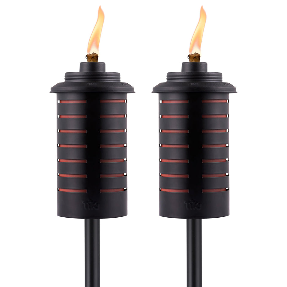 TIKI metal black orange torch full-size 64-inch setup for dramatic backyard lighting.