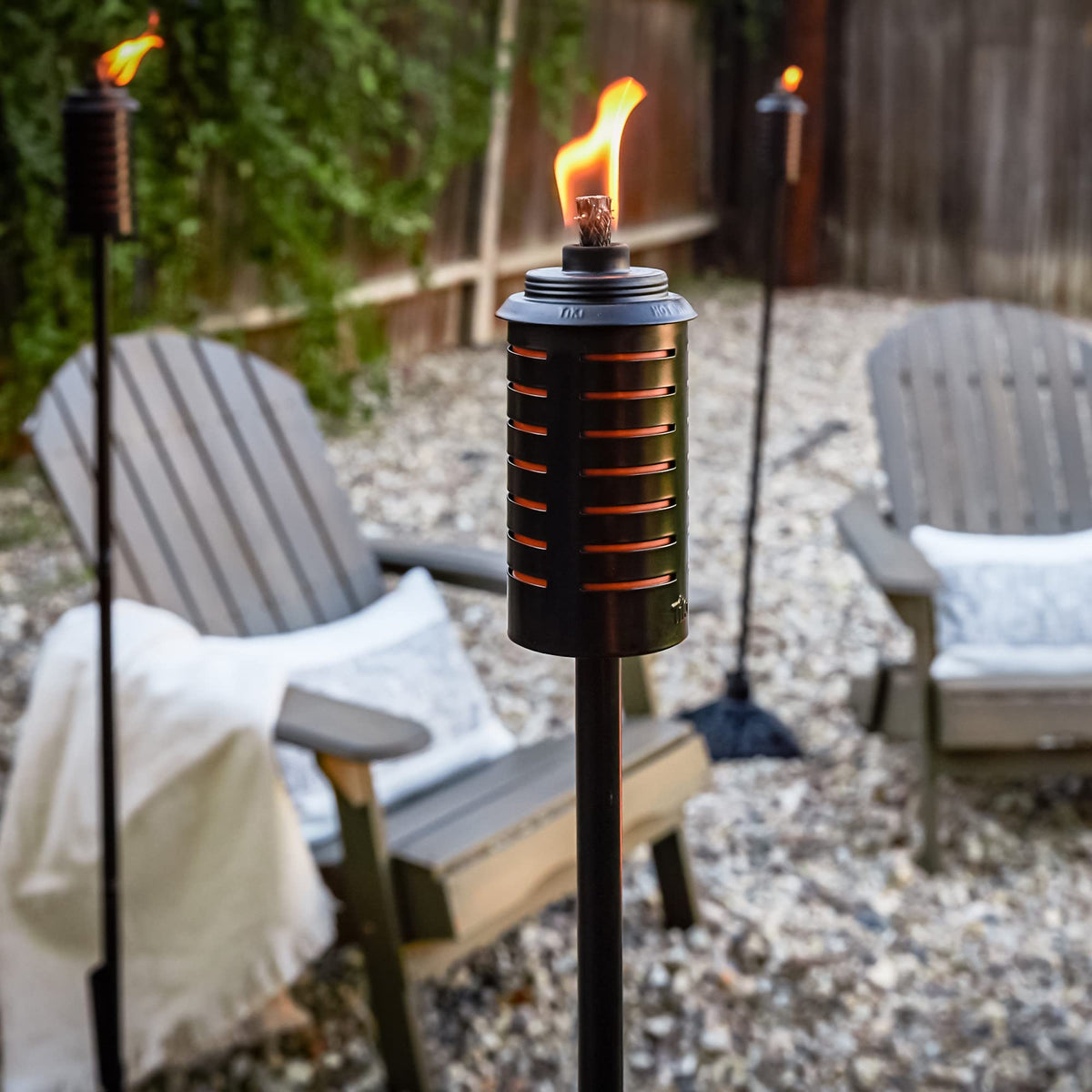 TIKI metal black orange torch mid-size 49-inch mode for versatile garden lighting.