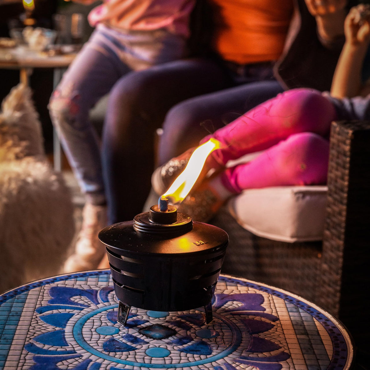 TIKI Mini Pit Table Torch includes long-lasting wick and metal snuffer for safe extinguishing.
