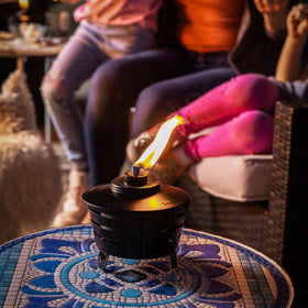 TIKI Mini Pit Table Torch includes long-lasting wick and metal snuffer for safe extinguishing.