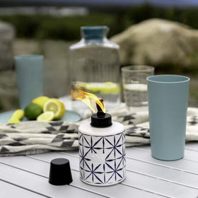 TIKI table torch with metal snuffer for easy extinguishing.